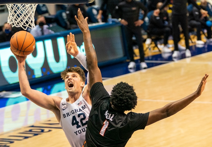 (Rick Egan | The Salt Lake Tribune)  Brigham Young Cougars center Richard Harward (42) shoots as Pacific Tigers forward Jordan Bell (1) defends, in overtime action, between Brigham Young Cougars and Pacific Tigers, at the Marriott Center in Provo, on Saturday, Jan. 30, 2021.