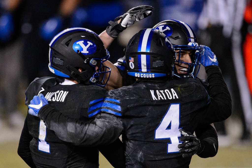 (Trent Nelson | The Salt Lake Tribune) Brigham Young Cougars quarterback Zach Wilson (1) celebrates the win with Brigham Young Cougars linebacker Isaiah Kaufusi (53) and Brigham Young Cougars running back Lopini Katoa (4) as BYU hosts San Diego State, NCAA football in Provo on Saturday, December 12, 2020.