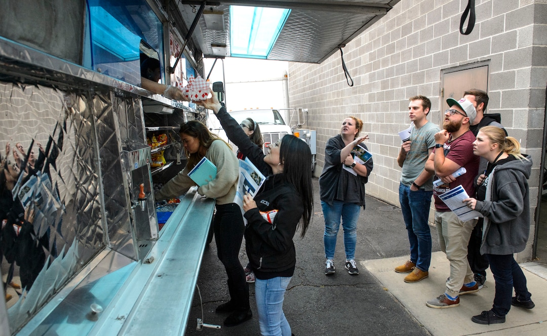 (Steve Griffin  |  The Salt Lake Tribune)  Access Development employees line up for a free food truck lunch on the company after attending an open enrollment benefits meeting at the South Salt Lake company on Nov. 16, 2017.