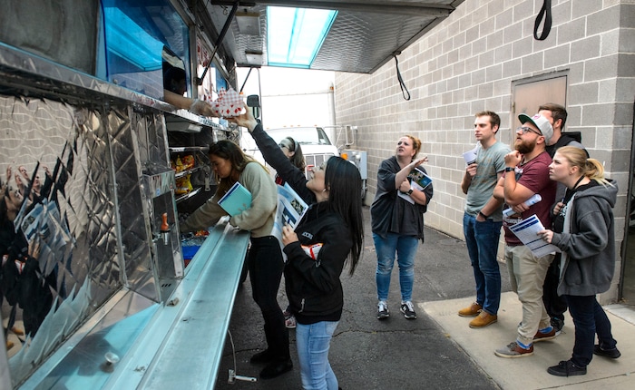 (Steve Griffin  |  The Salt Lake Tribune)  Access Development employees line up for a free food truck lunch on the company after attending an open enrollment benefits meeting at the South Salt Lake company on Nov. 16, 2017.