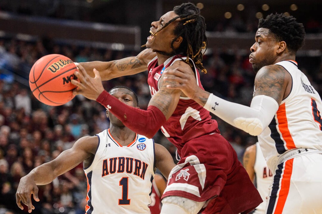(Trent Nelson | The Salt Lake Tribune)  New Mexico State Aggies guard Terrell Brown (3) defended by Auburn Tigers guard Jared Harper (1) and Auburn Tigers guard Malik Dunbar (4) as Auburn faces New Mexico State in the 2019 NCAA Tournament in Salt Lake City on Thursday March 21, 2019.