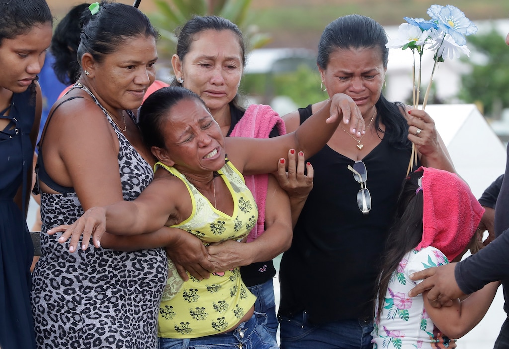(Andre Penner | The Associated Press) Antonia Alves grieves as she is comforted by relatives during the burial of her son Jairo Alves Figueiredo, an inmate who was killed in the recent prison riots, at a cemetery in Manaus, Brazil, Thursday, May 30, 2019. Families were burying victims of several prison riots in which dozens of inmates died in the northern Brazilian state of Amazonas, as authorities confirmed they had received warnings of an “imminent confrontation” days before the attacks begun.