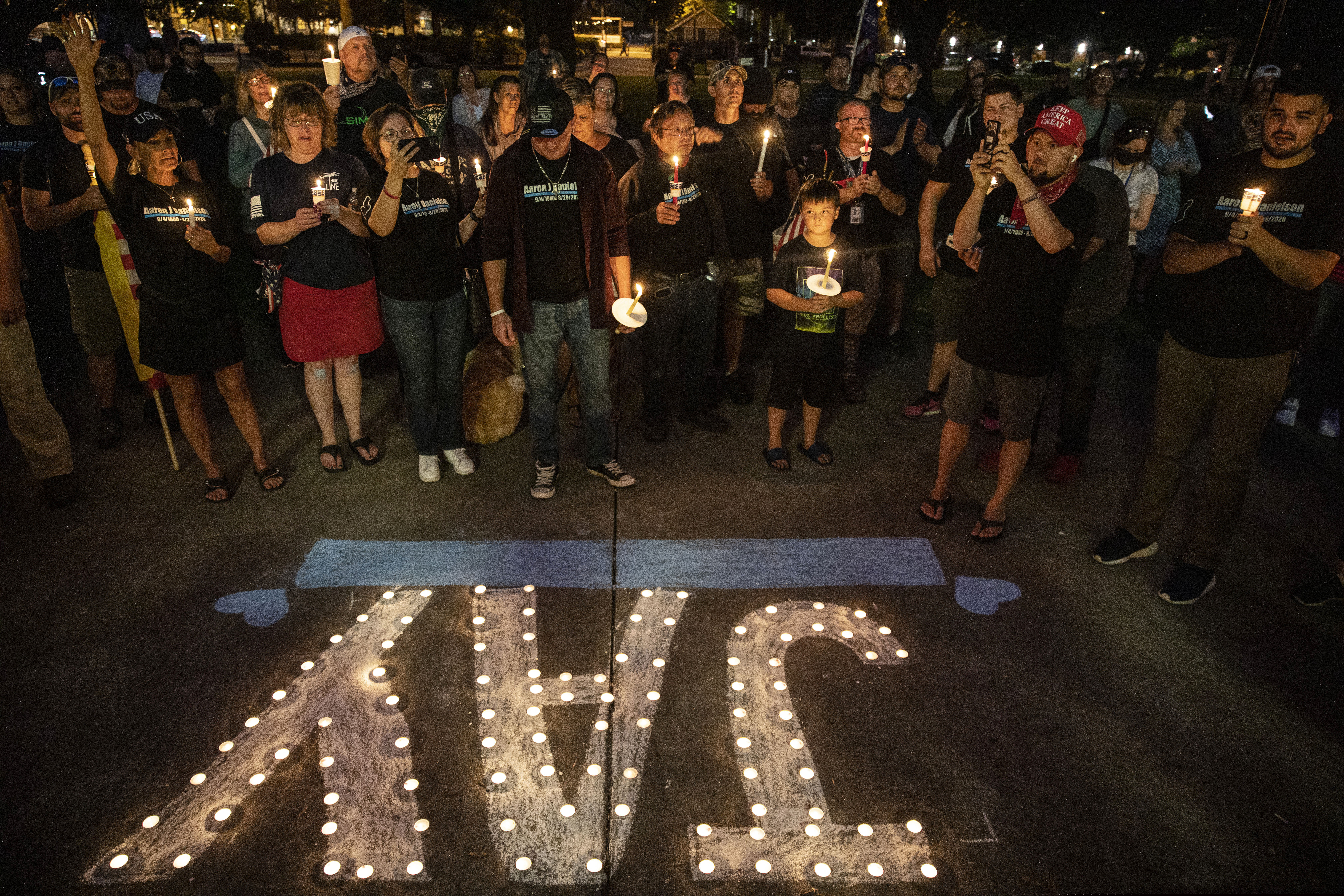 (Paula Bronstein | AP photo)

People hold candles during a vigil Sept. 5 in Vancouver, Wash., for Aaron "Jay" Danielson, a supporter of Patriot Prayer who was shot and killed a week ago in Portland, Ore.