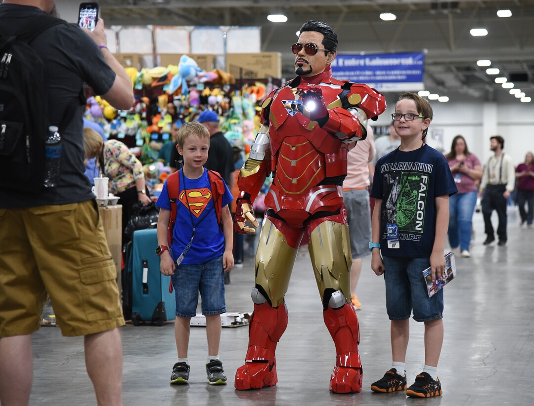(Francisco Kjolseth  |  The Salt Lake Tribune)  T.J. DeCarlo, a police officer with North Salt Lake dresses as Tony Stark as he poses for a photo with Owen Edwards, 7, left, and his brother Quinn, 8, as they attend the start of FanX Salt Lake Comic Convention at the Salt Palace in Salt Lake City Thursday, Sept. 6, 2018, during the three-day pop culture convention.