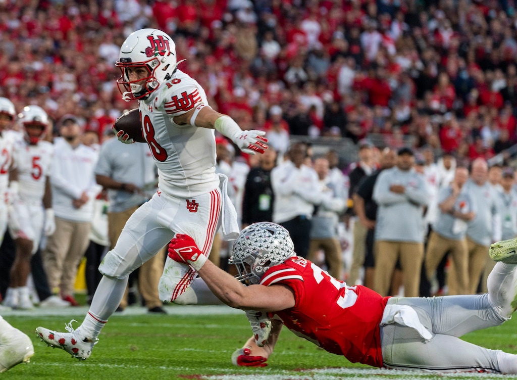 (Rick Egan | The Salt Lake Tribune)   Ohio State Buckeyes linebacker Tommy Eichenberg (35) tries to bring down Utah Utes wide receiver Britain Covey (18) in football action between Utah Utes and Ohio State Buckeyes in the Rose Bowl in Pasadena, Calif., on Saturday, Jan. 1, 2022.