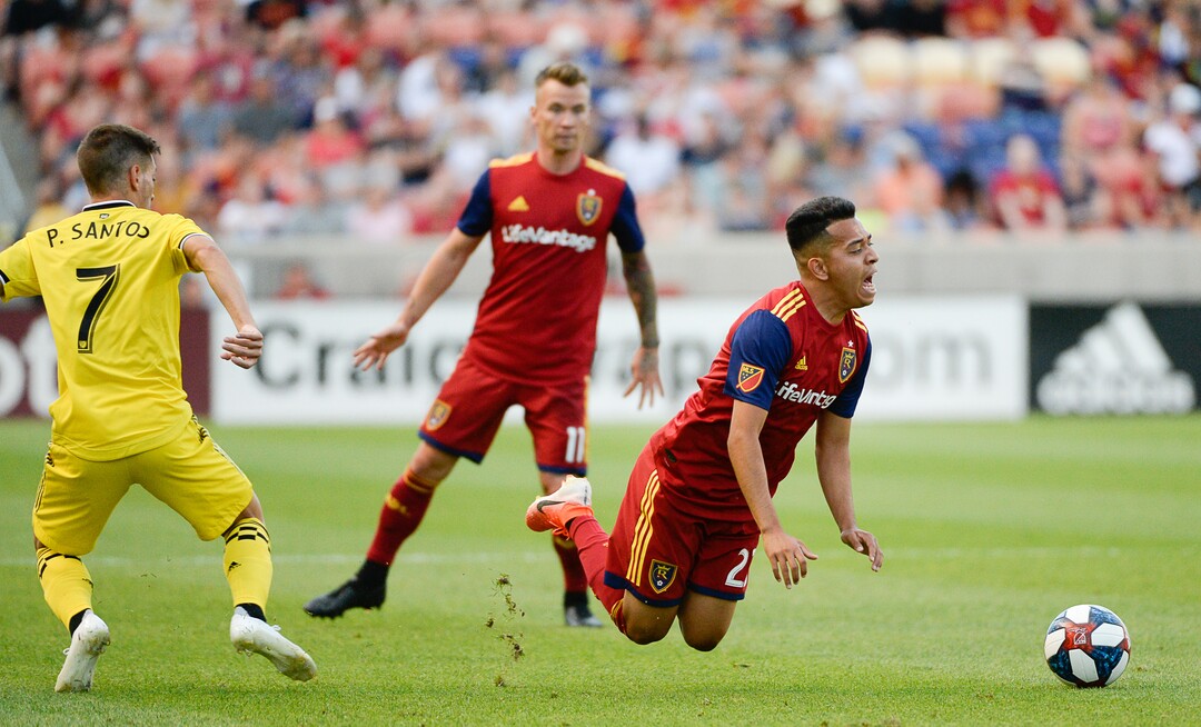 (Francisco Kjolseth  |  The Salt Lake Tribune)  Columbus Crew forward Pedro Santos (7) trips up Real Salt Lake midfielder Sebastian Saucedo (23) as Real Salt Lake hosts Columbus Crew SC, in MLS Soccer at Rio Tinto Stadium in Sandy, Utah on Wed, July 3, 2019.