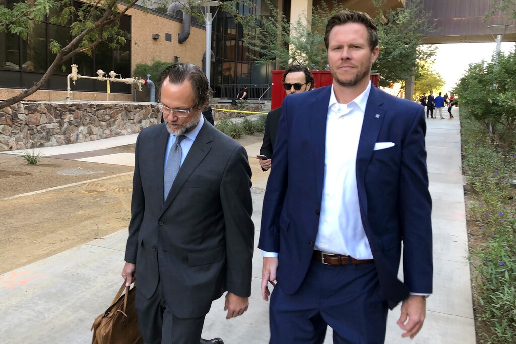 (Jacques Billeaud | AP file photo) Former Maricopa County Assessor Paul Petersen, right, walks with his attorney, Kurt Altman, as they leave a court hearing in Phoenix, Nov. 5, 2019. Petersen, who has acknowledged running an adoption scheme in three states that involved women from the Marshall Islands, is required to report to federal prison by midday Thursday, Jan. 21, 2021, to start serving a 6-year sentence for his guilty plea in Arkansas to conspiring to commit human smuggling. Petersen also is awaiting sentencing for related convictions in Arizona and in Utah.