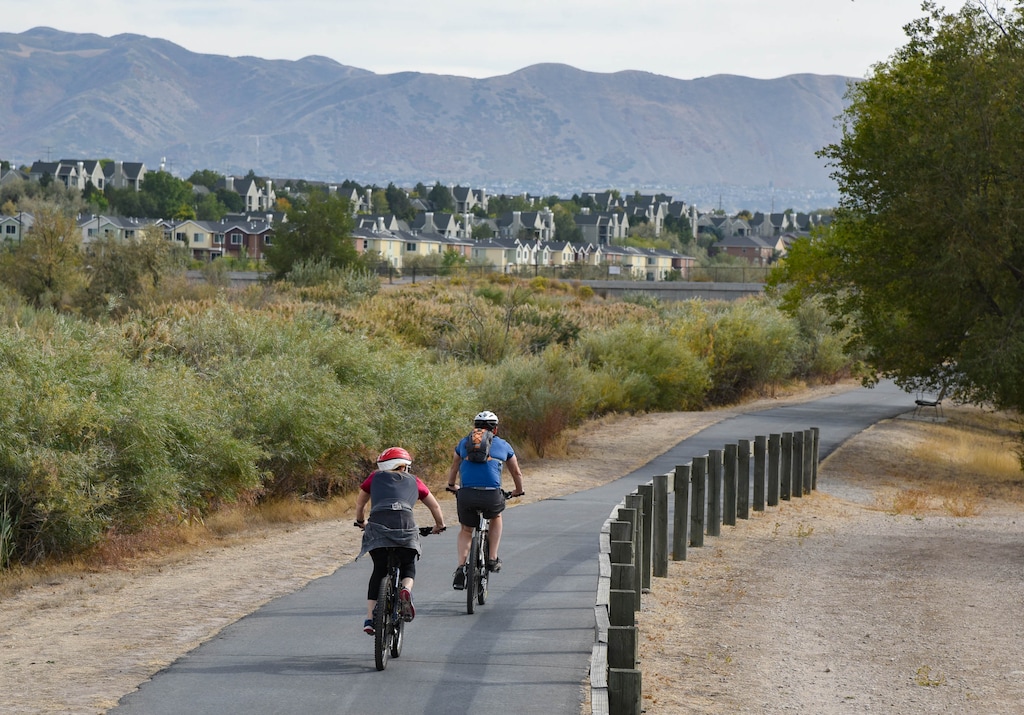 (Francisco Kjolseth  |  The Salt Lake Tribune) Cyclists pedal on the Jordan River Parkway in South Jordan on Friday, Oct. 2, 2020.