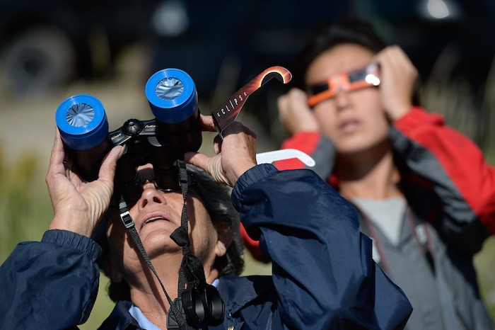 (Francisco Kjolseth  |  The Salt Lake Tribune)  Cheryl Kennedy specially filtered binoculars to take in the total eclipse of the sun from the edge of Palisades Reservoir, Idaho, on Monday, August 21, 2017.