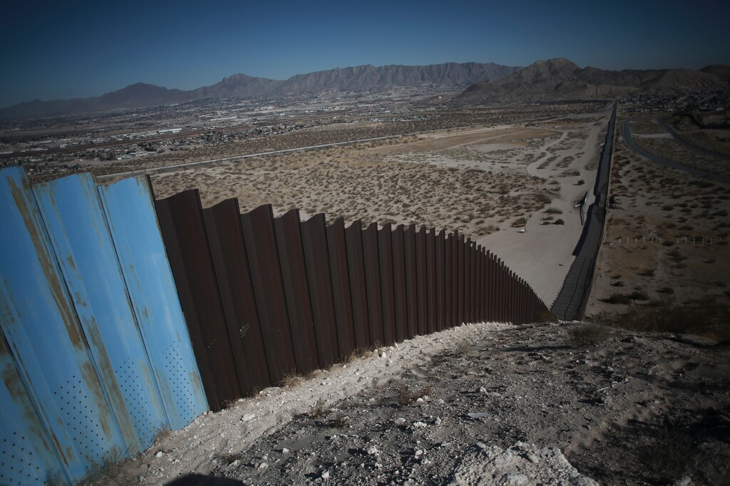 (Christian Chavez | AP) An older section of the border wall divides Ciudad Juarez, Mexico, from Sunland Park, New Mexico, top, on the outskirts of Ciudad Juarez, Mexico, Tuesday, Jan. 12, 2021.
