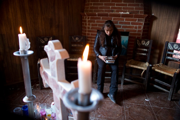 In this Aug. 18, 2017 photo, Juana Pedraza sits beside an altar to her 29-year-old daughter, Jessica, inside the family's home in Villa Cuauhtemoc, Mexico state. Jessica's disappearance, on a Friday in August, set off a frantic 48 hours of searching by the family. Under the gender violence alert issued two years earlier, authorities are supposed to investigate any woman's disappearance urgently. But Pedraza said authorities told her to wait until Sunday afternoon. (AP Photo/Rebecca Blackwell)