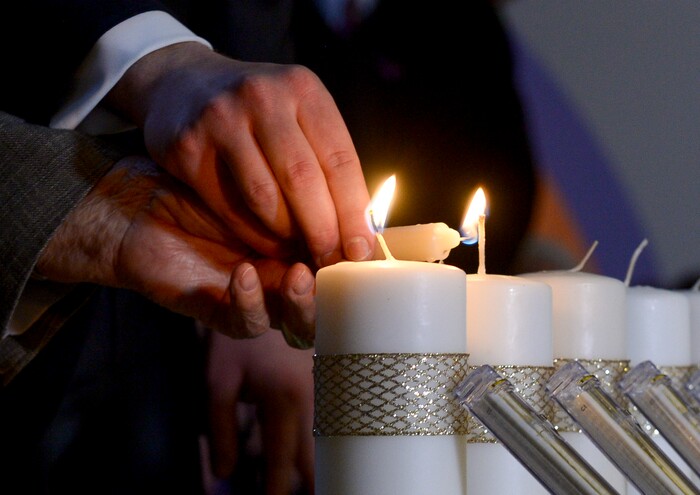 Leah Hogsten | The Salt Lake Tribune Holocaust survivor Abe Katz is aided by Rabbi Avremi Zippel as 11 candles representing those killed during Saturday's shooting at the Tree of Life Synagogue in Pittsburgh are remembered during an interfaith service at Chabad Lubavitch of Utah, Monday, Oct. 29, 2018. Hundreds attended the vigil and prayer service to pray "for peace, harmony and love to once again reign supreme upon this Earth."