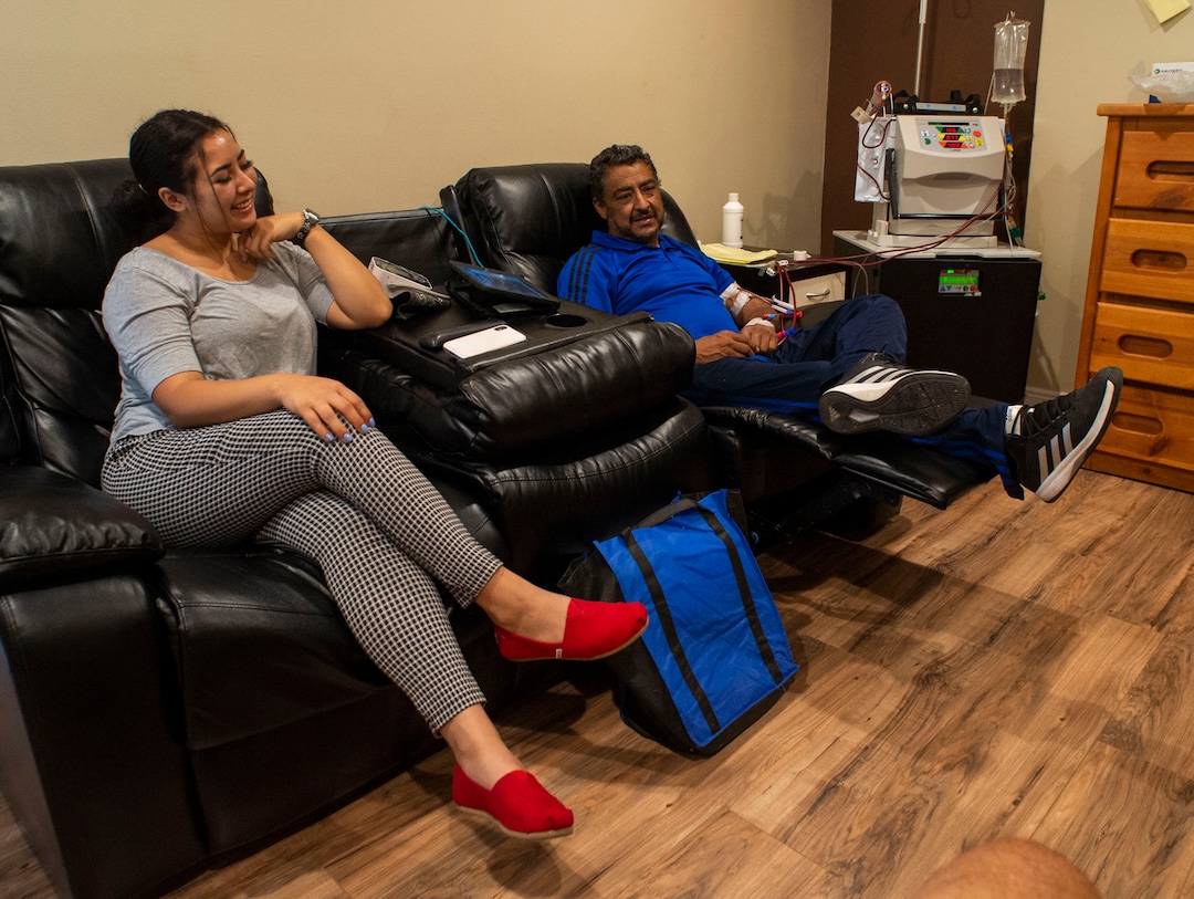 (Rick Egan  |  The Salt Lake Tribune)     Jackie Gutierrez sits with her father, Raul Gutierrez, during his in-home dialysis, at their home in Kearns. Thursday, Sept. 5, 2019.