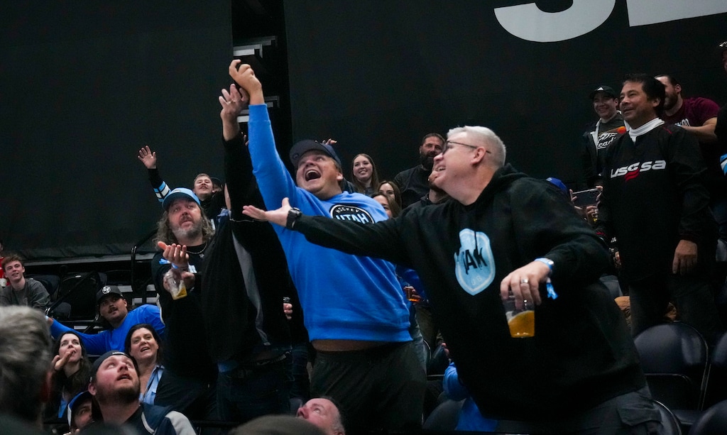 (Bethany Baker  |  The Salt Lake Tribune) Fans catch a puck thrown into the bleachers during the game between the Utah Hockey Club and the Ottawa Senators at the Delta Center in Salt Lake City on Tuesday, Oct. 22, 2024.