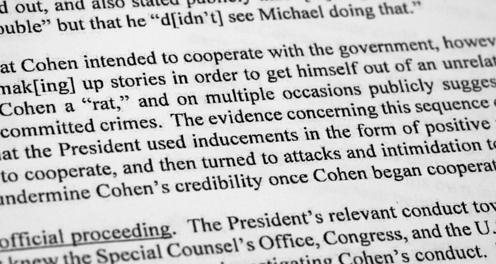 Special counsel Robert Mueller's redacted report on the investigation into Russian interference in the 2016 presidential election is photographed Thursday, April 18, 2019, in Washington. Pictured is a section regarding Michael Cohen. (AP Photo/Jon Elswick)