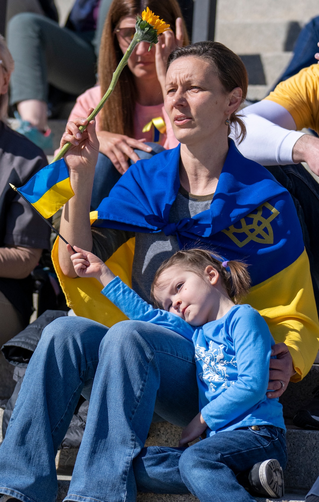 (Rick Egan | The Salt Lake Tribune) Anya Beus and her daughter Katya Bues, 5, listen to a song, on the Capitol steps for a protest against Russia's invasion of Ukraine, organized by the Utah Ukrainian association, on Saturday, March 12, 2022.