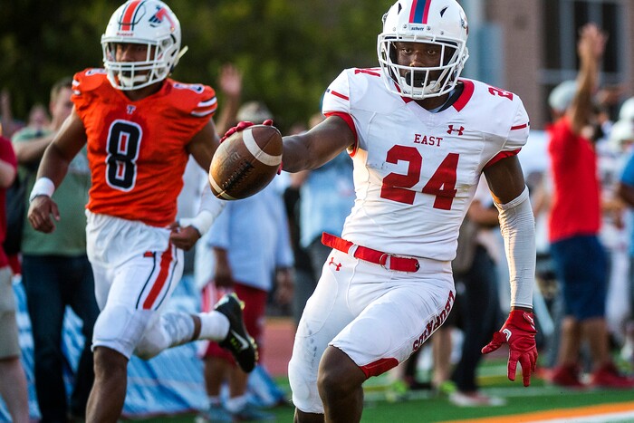 (Chris Detrick  |  The Salt Lake Tribune)  East's Jaylon Vickers (24) scores a touchdown past Timpview's Tevita Foketi (8) during the game at Timpview High School Thursday, August 17, 2017. 