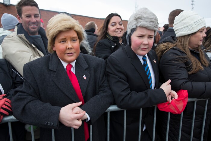 Supporters dressed up as President Donald Trump and Vice President Mike Pence look on as Trump arrives at Salt Lake City International Airport, Monday, Dec. 4, 2017, in Salt Lake City. (AP Photo/Evan Vucci)