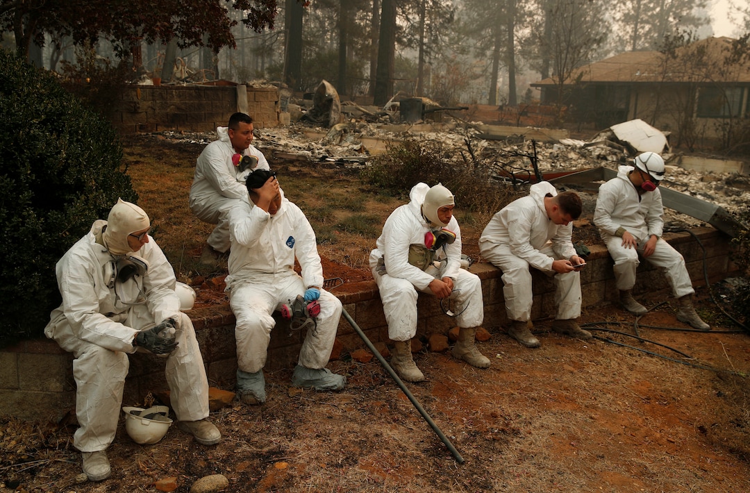 Members of the California Army National Guard take a break at they search burned homes for human remains at the Camp Fire, Thursday, Nov. 15, 2018, in Paradise, Calif. (AP Photo/John Locher)