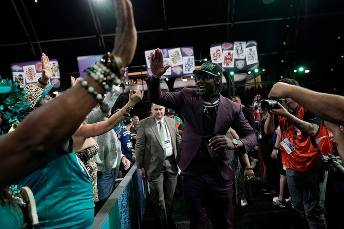 Utah linebacker Devin Lloyd celebrates with supporters after being chosen by the Jacksonville Jaguars with the 27th pick of the NFL football draft Thursday, April 28, 2022, in Las Vegas. (AP Photo/Jae C. Hong)