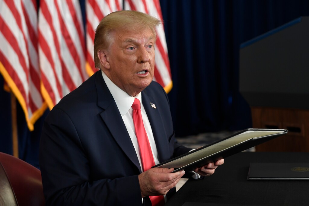 (Susan Walsh | AP photo)

President Donald Trump prepares to sign four executive orders during a news conference at the Trump National Golf Club in Bedminster, N.J., Aug. 8. Seizing the power of his podium and his pen, Trump on Saturday moved to bypass the nation's elected lawmakers as he claimed the authority to defer payroll taxes and extend an expired unemployment benefit after negotiations with Congress on a new coronavirus rescue package collapsed.