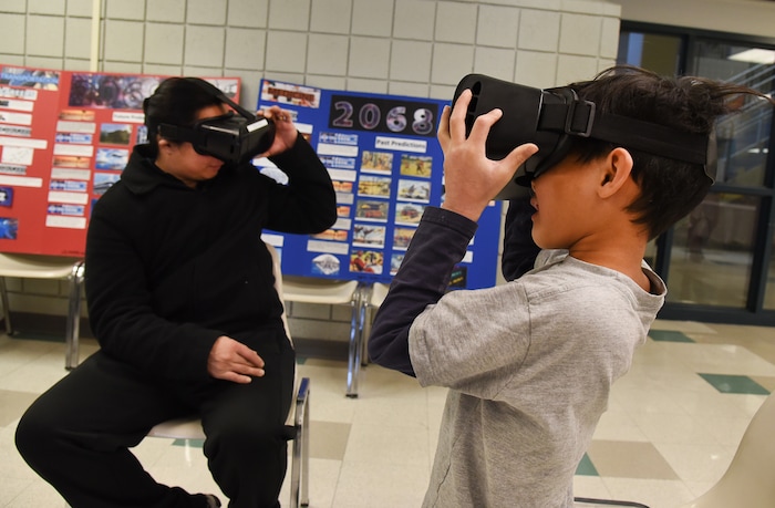 (Francisco Kjolseth  |  The Salt Lake Tribune)  Jonas Orbiso and his son Anthony, 7, immerse themselves in a virtual world as Salt Lake City's Winter De-Stressor Festival at the Horizonte Instruction and Training Center on Saturday, Dec. 15, 2018. The event helped families identify and locate services for youths during between Christmas and New Years. When school is out for winter break, it can have an impact on the state's most vulnerable populations who face food insecurity, access to healthcare services, affordable childcare and safe places for their children.