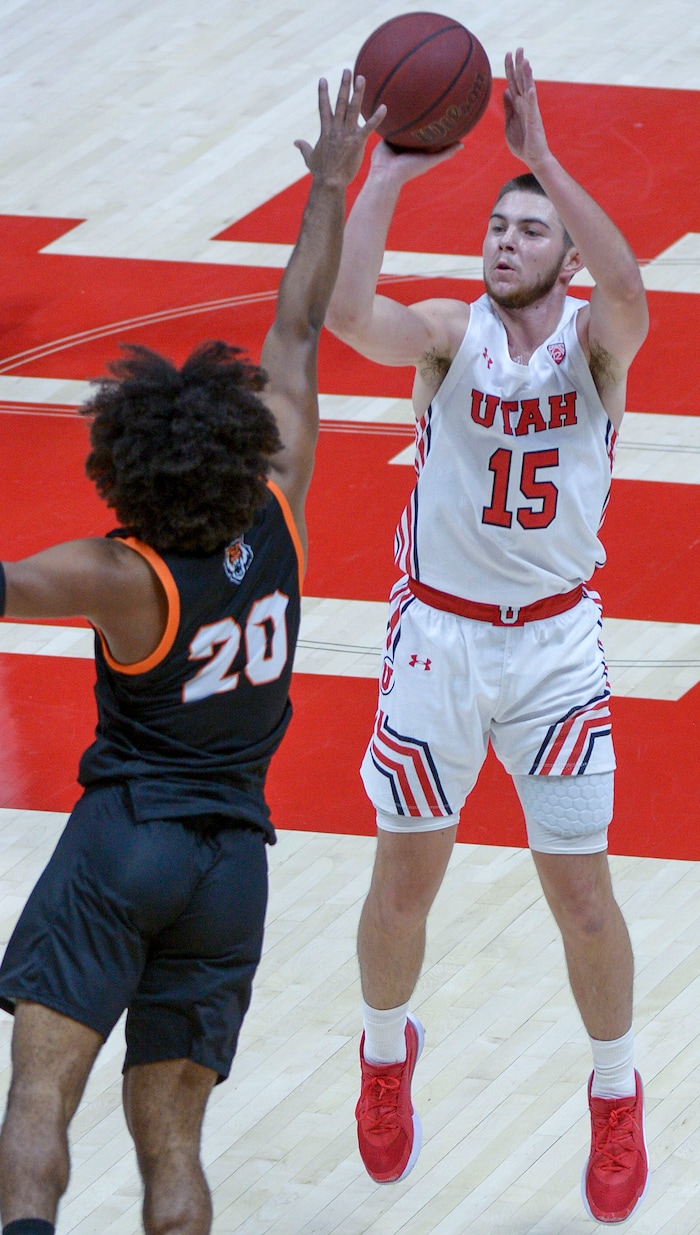 (Leah Hogsten  |  The Salt Lake Tribune) Utah Utes guard Rylan Jones (15) throws up a 3-pointer around Idaho State Bengals guard Robert Ford III (20) during their NCAA basketball matchup Tuesday, Dec. 8, 2020 at the Jon M. Huntsman Center.