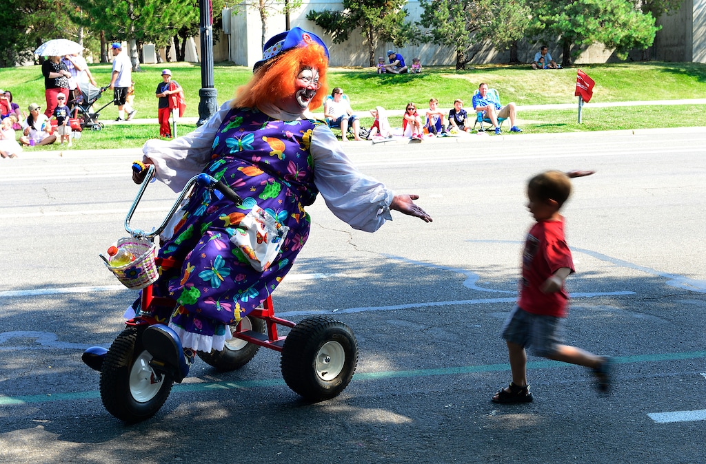(Scott Sommerdorf | The Salt Lake Tribune) A young boy rushes to slap hands with a clown during the annual Days of ’47 Youth Parade in 2014.