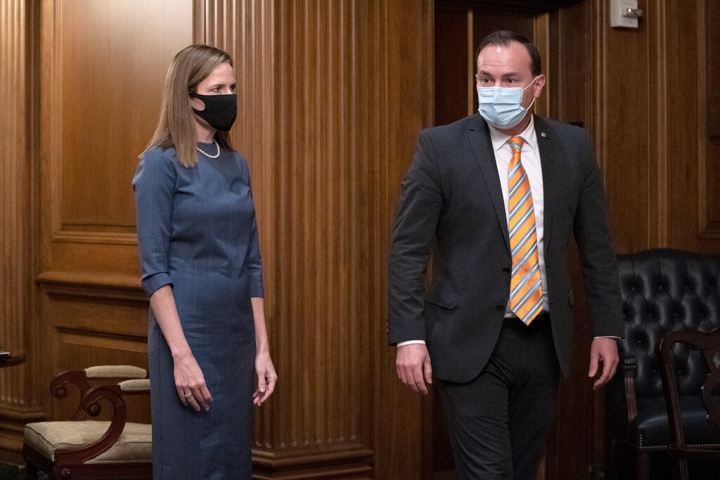 (Stefani Reynolds | Pool via AP file photo) Judge Amy Coney Barrett, President Donald Trump's nominee to the Supreme Court, meets with Sen. Mike Lee, R-Utah, on Sept. 29. After President Donald Trump announced he had tested positive for the coronavirus, Lee revealed he too had been infected with the disease.