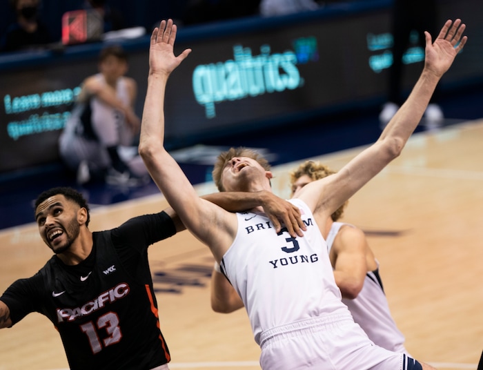(Rick Egan | The Salt Lake Tribune)  Brigham Young Cougars forward Matt Haarms (3) gets tangled up with Pacific Tigers forward Jeremiah Bailey (13), in basketball action, between the Brigham Young Cougars and the Pacific Tigers, at the Marriott Center in Provo, on Saturday, Jan. 30, 2021.