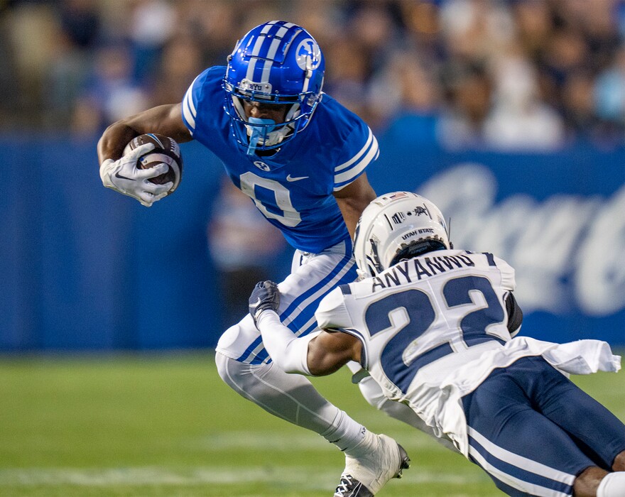 (Rick Egan | The Salt Lake Tribune) Brigham Young Cougars wide receiver Kody Epps (0) runs with the ball asm Utah State Aggies cornerback Michael Anyanwu (22) defends, in football action between the Brigham Young Cougars and the Utah State Aggies, at LaVell Edwards Stadium in Provo, on Thursday, Sept. 29, 2022.