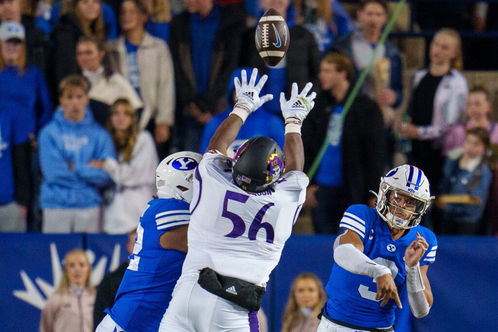 (Trent Nelson  |  The Salt Lake Tribune) East Carolina Pirates defensive lineman D'Anta Johnson (56) tips a pass by Brigham Young Cougars quarterback Jaren Hall (3) as BYU hosts East Carolina, NCAA football in Provo on Friday, Oct. 28, 2022.