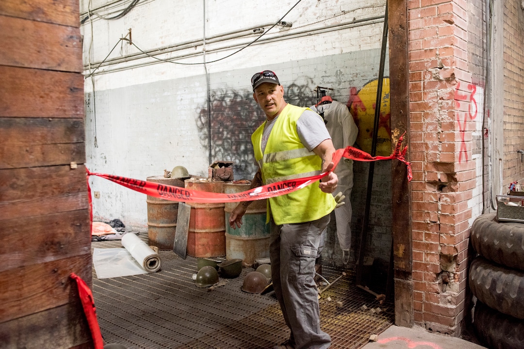 (Briana Scroggins  |  The Utah Investigative Journalism Project) EPA On-scene Coordinator Paul Peronard moves past red tape to a room that has large unidentified containers and a live electrical box at the Swift building in Ogden on Thursday, May 16, 2019. The EPA started site clean up on April 1 and plan to finish by August 2019.