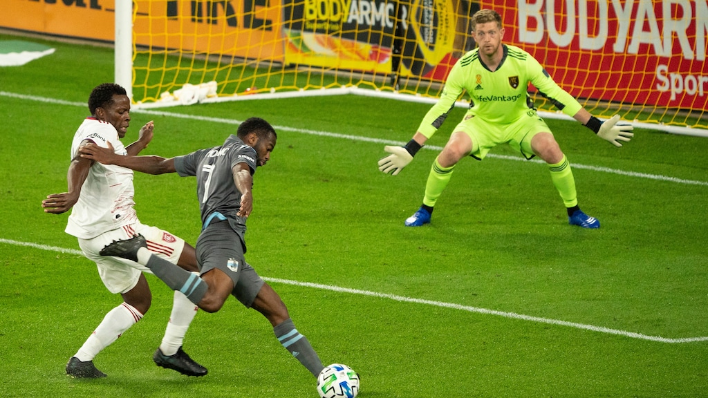 (Jeff Wheeler | Star Tribune via AP) Minnesota United midfielder Kevin Molino (7) takes a second half shot on Real Salt Lake goalkeeper Zac MacMath (18) while defended closely by Real Salt Lake's Nedum Onuoha (14) in an MLS soccer match, Sunday, Sept. 6, 2020, at Allianz Field in St. Paul, Minn.