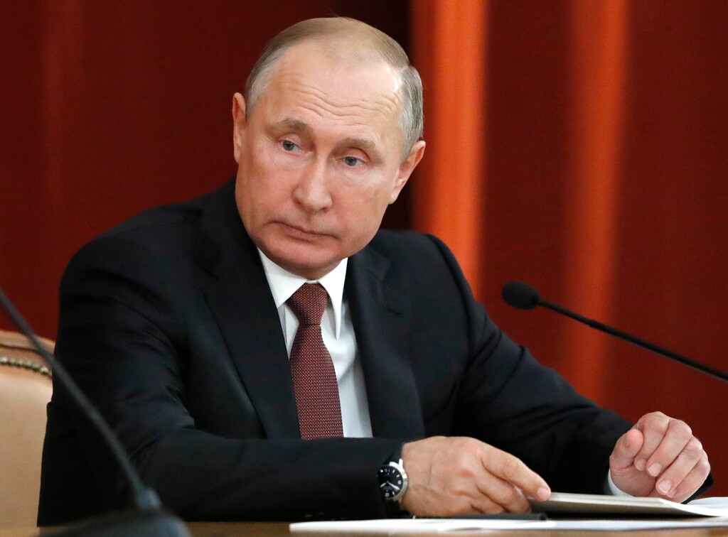 Russian Vladimir Putin attends a meeting with Russian ambassadors to foreign countries in Moscow, Russia, Thursday, July 19, 2018. Putin says his first summit with U.S. President Donald Trump was "successful" and is accusing Trump's opponents in the U.S. of hampering any progress on the issues they discussed. (Sergei Karpukhin/Pool Photo via AP)