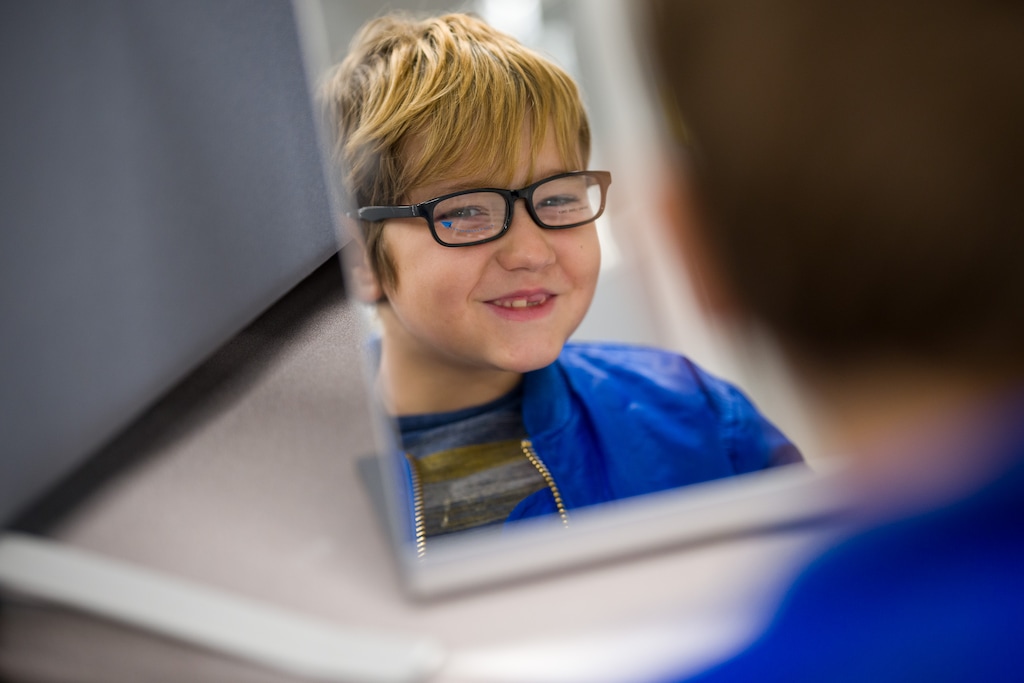 (Trent Nelson | The Salt Lake Tribune) Second grader Emmett Knight tries on frames at the vision clinic in Salt Lake City's Parkview Elementary on Friday, Dec. 1, 2023. The new clinic offers optometry services to Salt Lake City students and their families. Care is free to those who qualify, but the clinic also accepts some kinds of insurance.