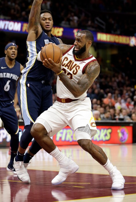 Cleveland Cavaliers' LeBron James, right, drives past Memphis Grizzlies' Jarell Martin in the first half of an NBA basketball game, Saturday, Dec. 2, 2017, in Cleveland. (AP Photo/Tony Dejak)
