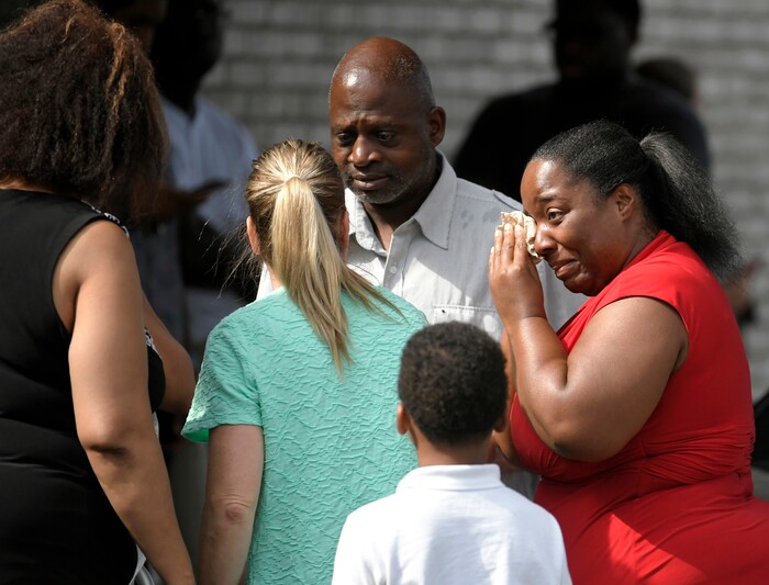 Ieshea White cries tears of joy after being reunited with her uncle Roger Bracey, center, who was at Burnette Chapel Church of Christ when shots were fired Sunday, Sept. 24, 2017, in Antioch, Tenn. They were reunited at another nearby church. (Shelley Mays/The Tennessean via AP)