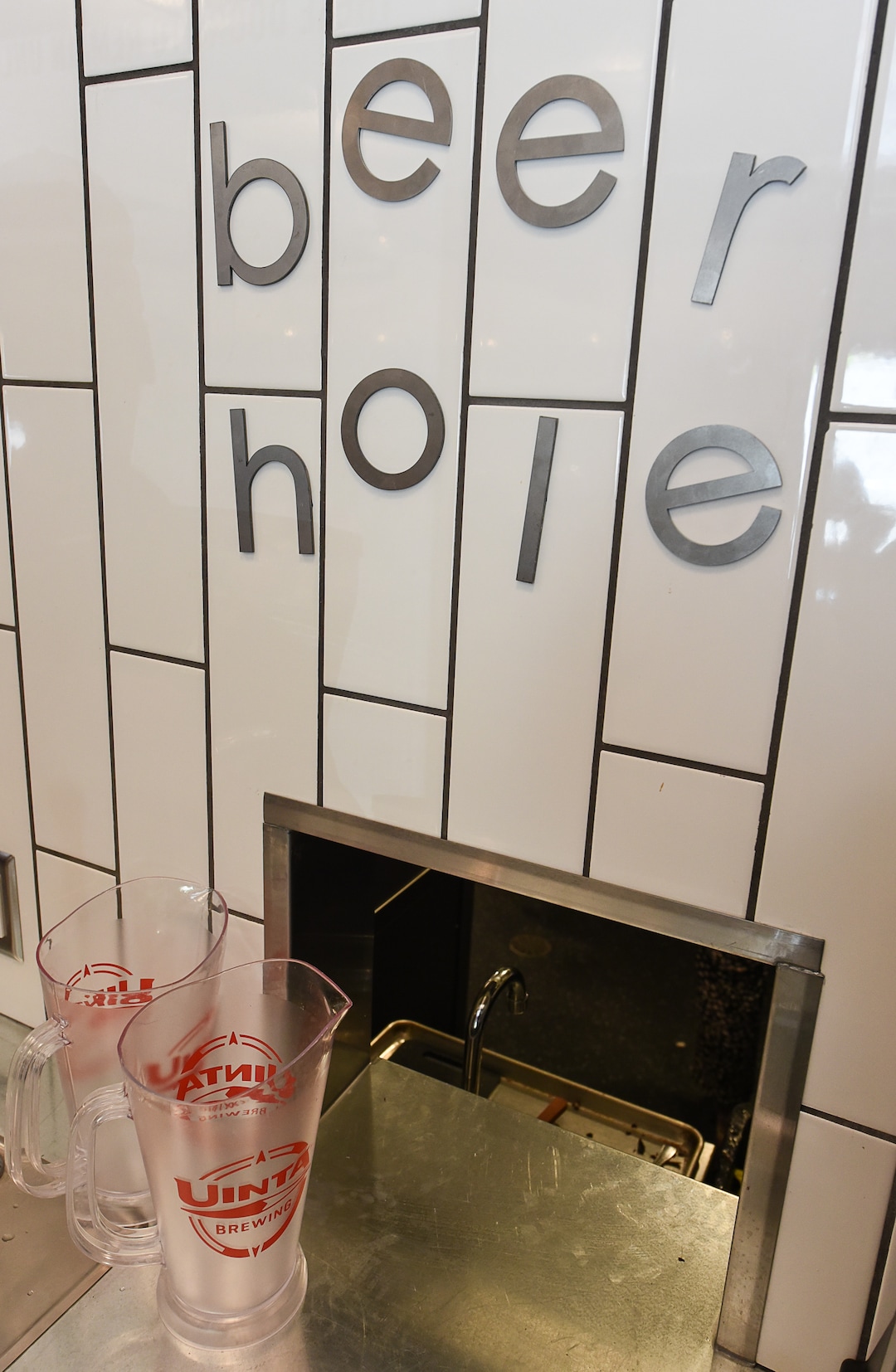(Francisco Kjolseth  |  The Salt Lake Tribune)  To meet state liquor law requirements, the beer taps were placed behind the wall in the kitchen and the pint glasses are served through a window, lovingly labeled the "beer hole.”