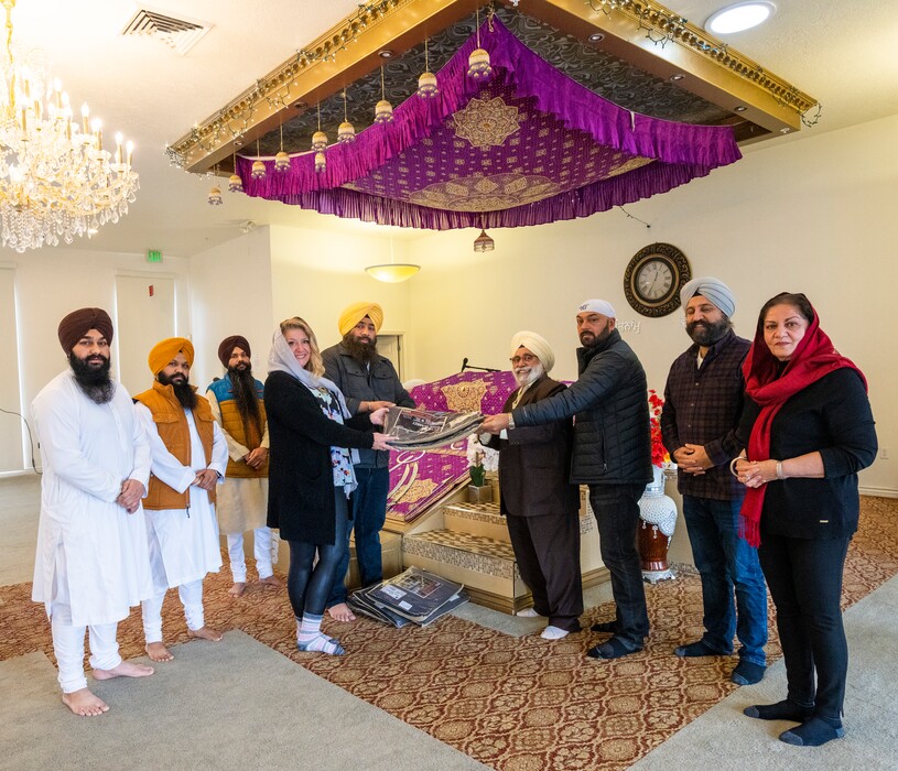 (Rick Egan | The Salt Lake Tribune) Members of the Sikh community present wool blankets to Carin Crowe from Habitat for Humanity to distribute to the help the unsheltered stay warm, during a blessing ceremony at the Sikh temple in Taylorsville, on Thursday, Dec. 23, 2021.