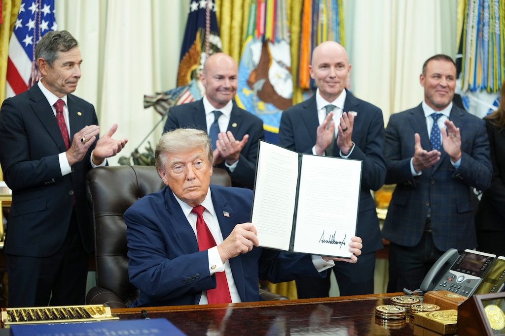(Doug Mills | The New York Times) President Donald Trump holds up a signed executive order reducing the size of Bears Ears and Grand Staircase-Escalante National Monuments in Utah in the Oval Office of the White House in Washington, on Monday, July 13, 2026. Behind Trump, from left, are U.S. Sens. John Curtis and Mike Lee, Gov. Spencer Cox, and House Speaker Mike Schultz, R-Hooper.