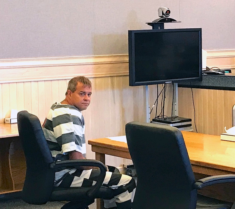 (Steve Ranson/Lahontan Valley News via AP) John K. O'Connor looks back before the judge reads an indictment in justice court, Wednesday, July 25, 2018 in Fallon, Nev. O'Connor, a 48-year-old northern Nevada man accused of fatally shooting a fellow member of his congregation during Sunday services at a Mormon church has been indicted on murder, battery and assault charges.