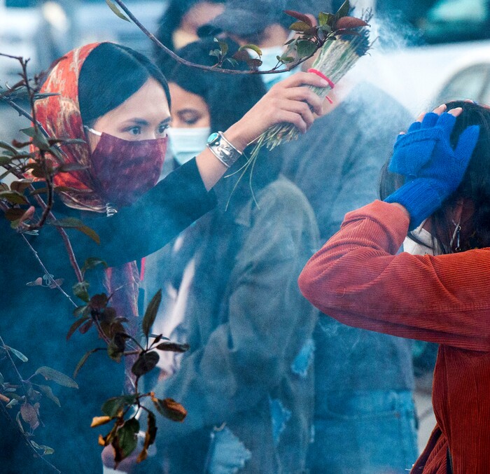 (Rick Egan  |  The Salt Lake Tribune)    A woman is blessed with smoke during the Indigenous Peoples Day celebration, on Monday, Oct. 12, 2020.