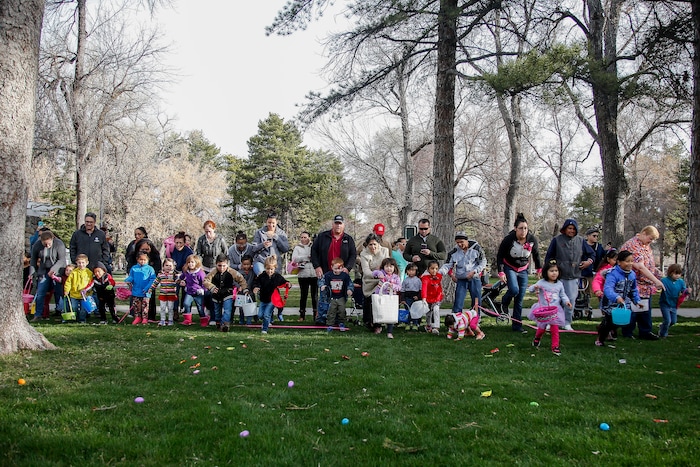 (Nicole Boliaux | For The Tribune) Children and their families run to grab Easter eggs during the annual Easter egg hunt put on by A Kid's Place Dentistry in Liberty Park in Salt Lake City on Saturday, March 31, 2018.