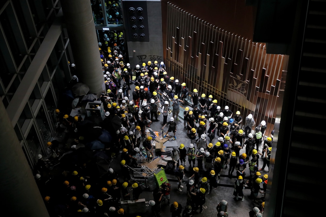 (Kin Cheung | AP Photo) Protesters gather inside the Legislative Council building in Hong Kong, Monday, July 1, 2019. Protesters in Hong Kong took over the legislature's main building Monday night, tearing down portraits of legislative leaders and spray painting pro-democracy slogans on the walls of the main chamber.