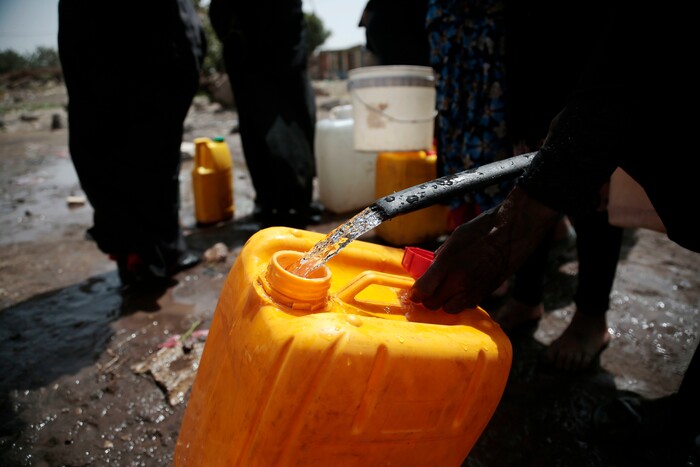 In this photo taken on Wednesday, Jul. 12, 2017, a women fills a bucket with water from a well that alleged to be contaminated water with the bacterium Vibrio cholera, on the outskirts of Sanaa, Yemen. Yemen’s raging two-year conflict has served as an incubator for lethal cholera. (AP Photo/Hani Mohammed)