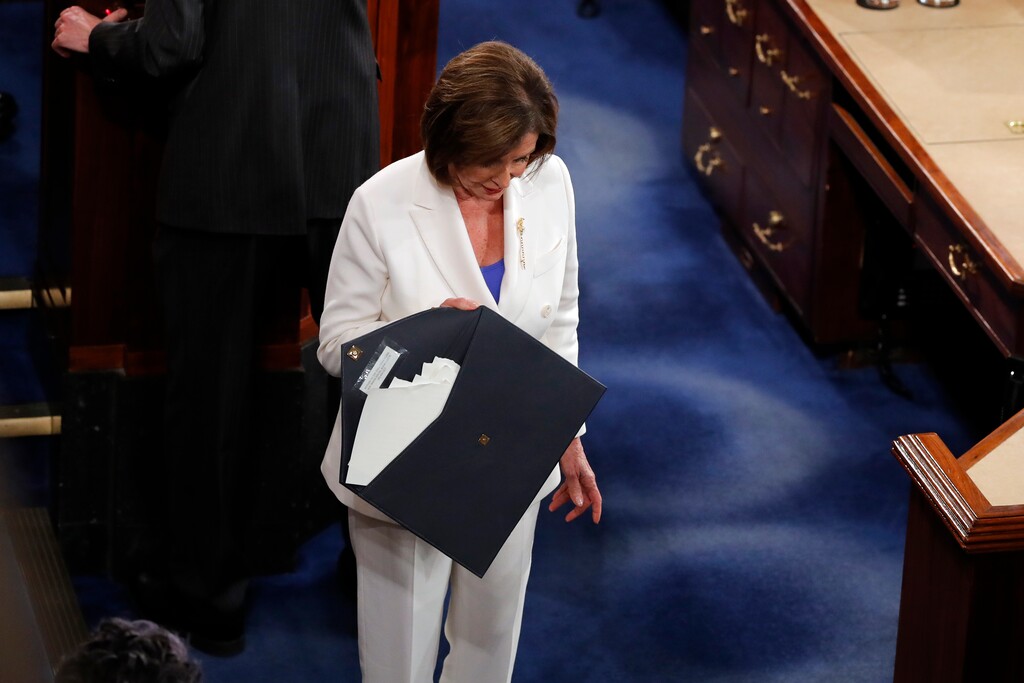 (J. Scott Applewhite | AP) House Speaker Nancy Pelosi of Calif., walks with the envelope that holds the copy of President Donald Trump's State of the Union address she tore up after he delivered it to a joint session of Congress on Capitol Hill in Washington, Tuesday, Feb. 4, 2020.
