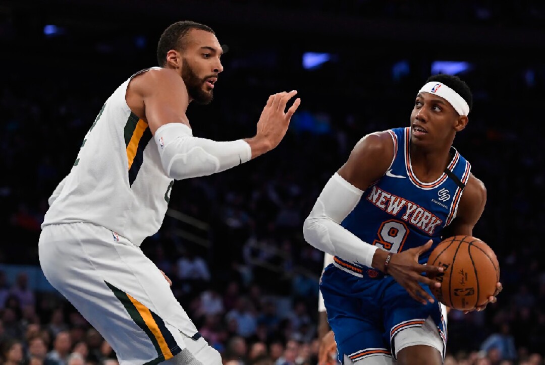 New York Knicks guard RJ Barrett (9) dribbles the ball as Utah Jazz center Rudy Gobert defends during the first half of an NBA basketball game in New York, Wednesday, March 4, 2020. (AP Photo/Sarah Stier