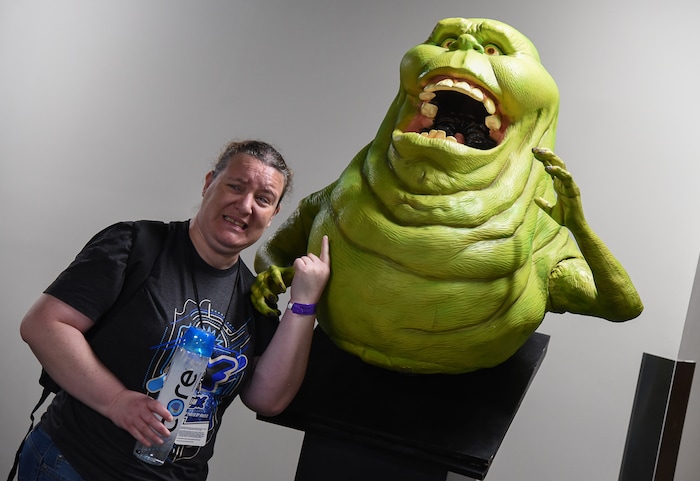 (Francisco Kjolseth  |  The Salt Lake Tribune)  Megan McFarland of Kaysville has her picture taken with Slimer from Ghost Busters as she attends the start of FanX Salt Lake Comic Convention at the Salt Palace in Salt Lake City Thursday, Sept. 6, 2018, during the three-day pop culture convention.