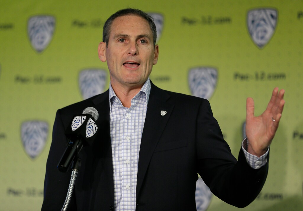 FILE - In this Oct. 12, 2017, file photo, Pac-12 commissioner Larry Scott gestures while speaking a NCAA college basketball Pac-12 media day, in San Francisco. A Pac-12 task force on reforming college basketball is recommending an end to the NBA’s one-and-done rule, allowing players to return to school even after they are drafted, and that the NCAA facilitate access to agents for high school players. The Pac-12 announced the recommendations from its task force on Tuesday, March 13, 2018, and its report has been sent to the NCAA’s commission on college basketball, headed by former Secretary of State and Stanford University Provost Condoleezza Rice. (AP Photo/Eric Risberg, File)
